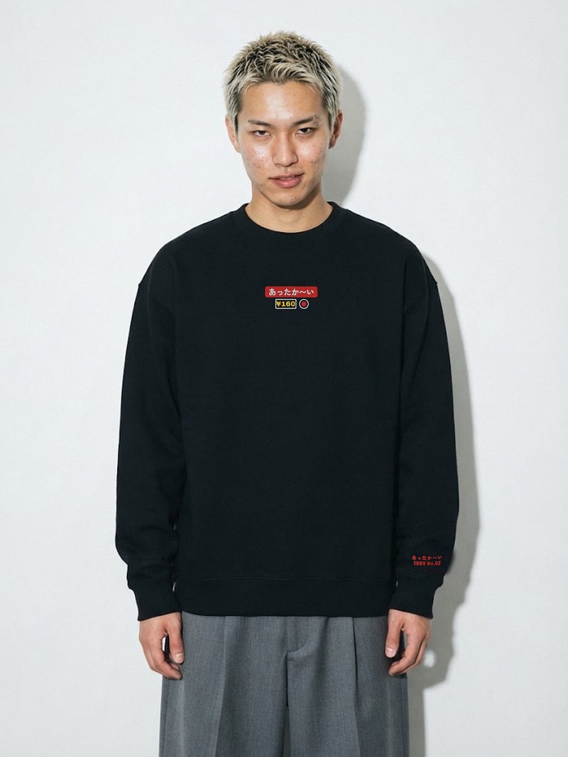 Model wearing the 5C5V Attaka-i あったか〜い heavyweight crewneck in Black, vending-machine button patch embroidered on the chest
