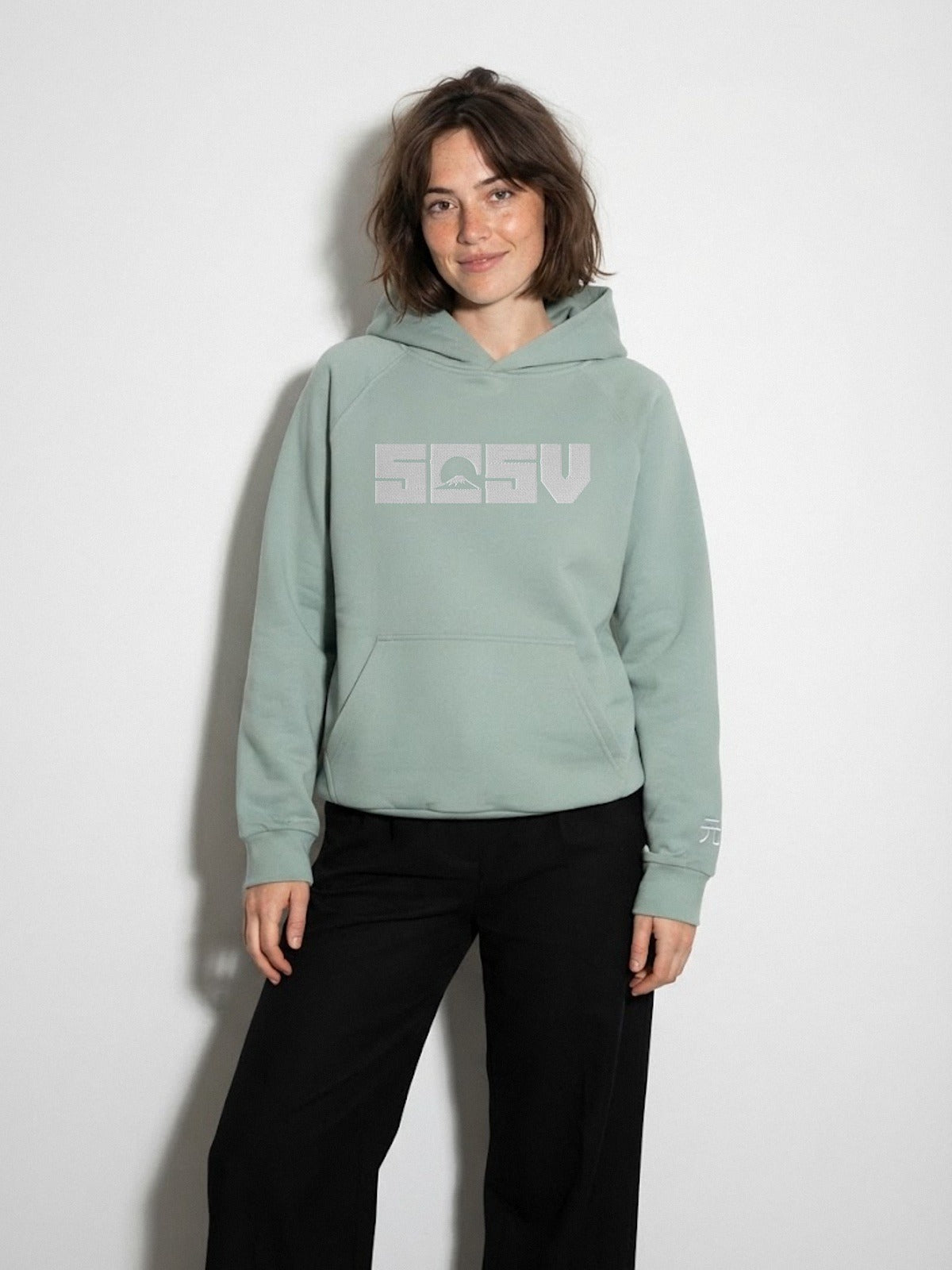 Model wearing the 5C5V Originals 元 heavyweight hoodie in Arona sage green, Mt Fuji 5C5V logo embroidered across the chest