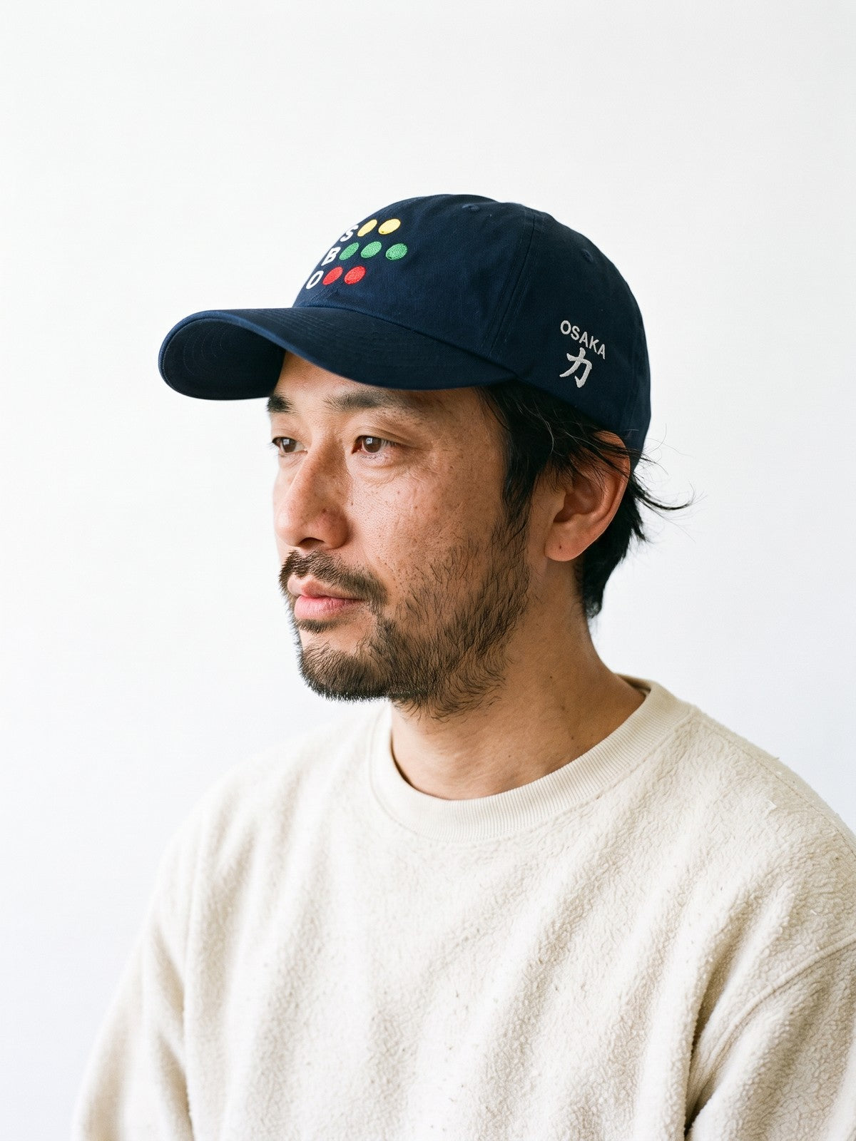 Side view of the 5C5V Osaka Full Count Japanese baseball cap in navy, OSAKA above 力 (strength) embroidered on the left side