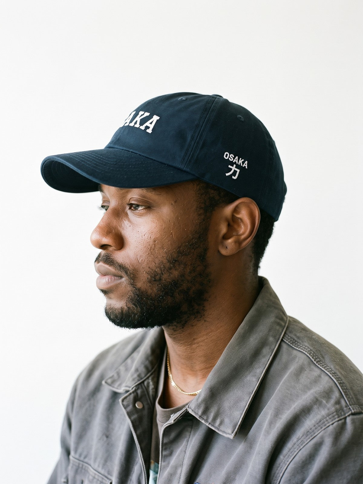 Side view of the 5C5V Osaka Varsity Japanese baseball cap in navy, OSAKA above 力 (strength) embroidered on the left side