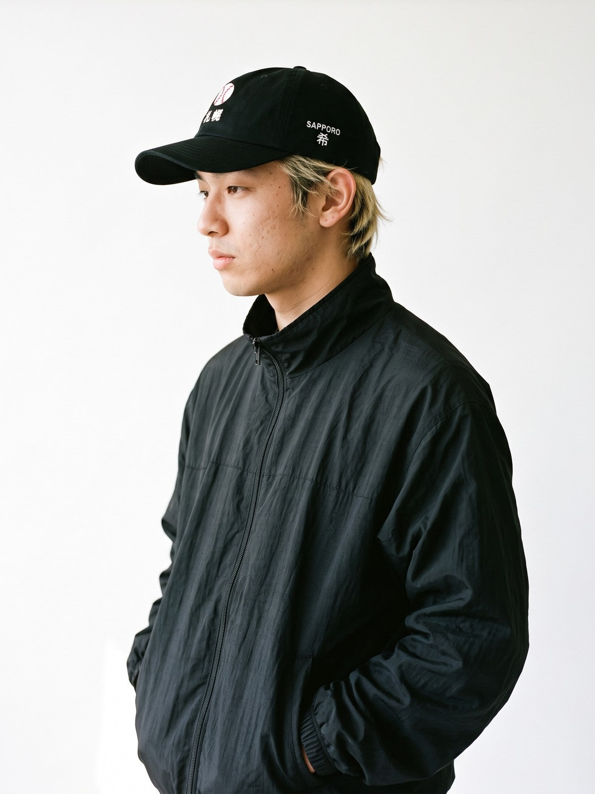 Side view of the 5C5V Sapporo Ball Japanese baseball cap in black, SAPPORO above 希 (hope) embroidered on the left side
