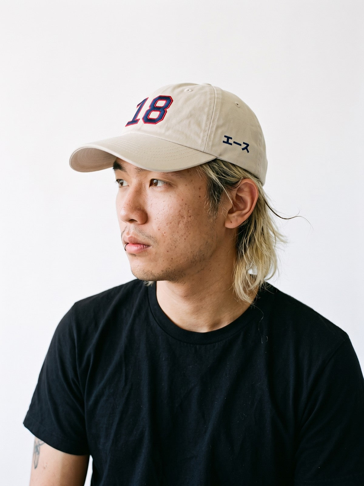 Side view of the 5C5V Ace 18 Japanese baseball cap in stone, エース (ace) in navy embroidered on the left side