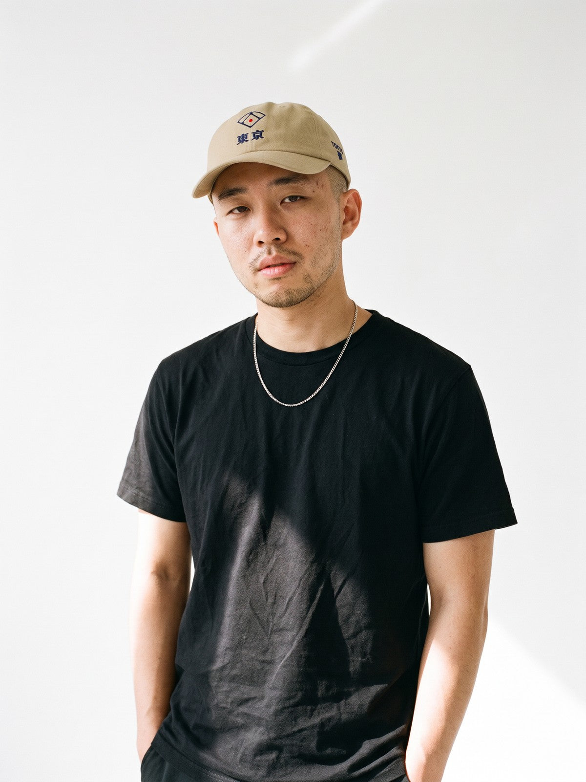 Model wearing the 5C5V Tokyo Diamond Japanese baseball cap in khaki, a baseball diamond over 東京 embroidered on the front, TOKYO and 夢 (dream) on the left side
