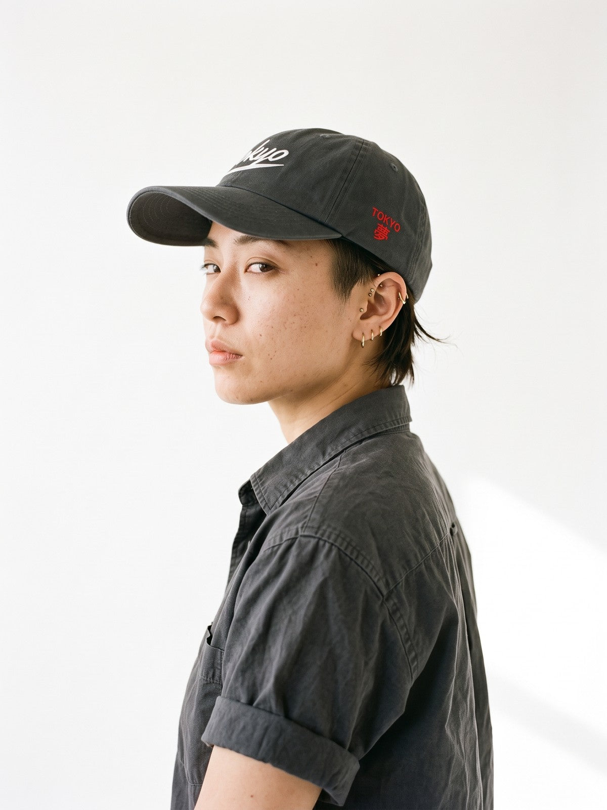 Side view of the 5C5V Tokyo Script Japanese baseball cap in dark grey, TOKYO above 夢 (dream) embroidered on the left side