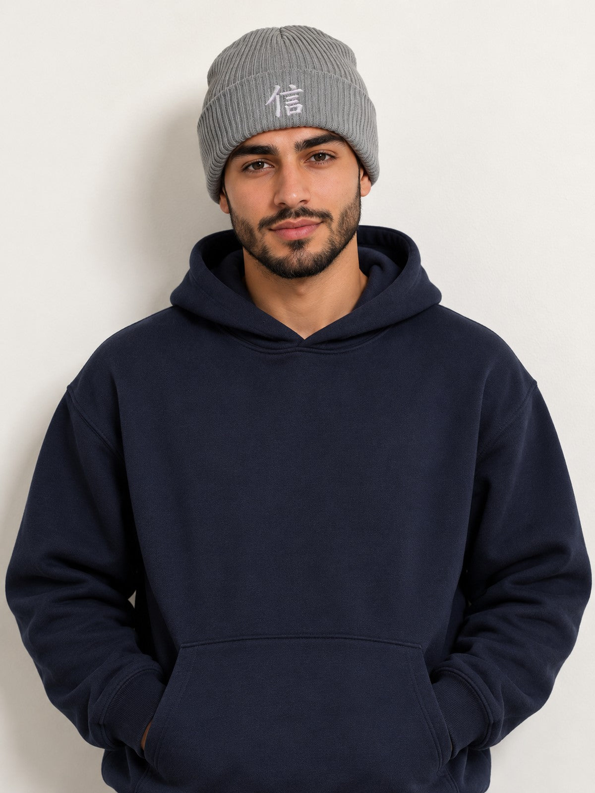 Model in a navy hoodie wearing the Light Grey 5C5V Yokohama Trust 信 ribbed beanie, front view