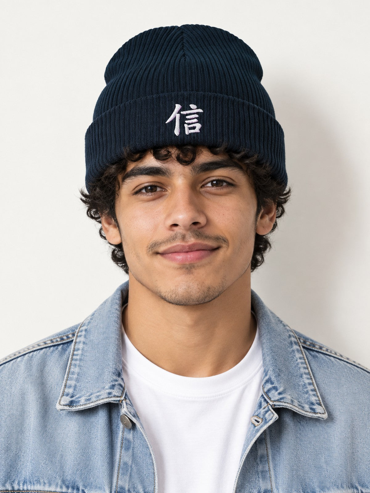 Model in a denim jacket wearing the Oxford Navy 5C5V Yokohama Trust ribbed beanie with 信 embroidered in white on the cuff, front view
