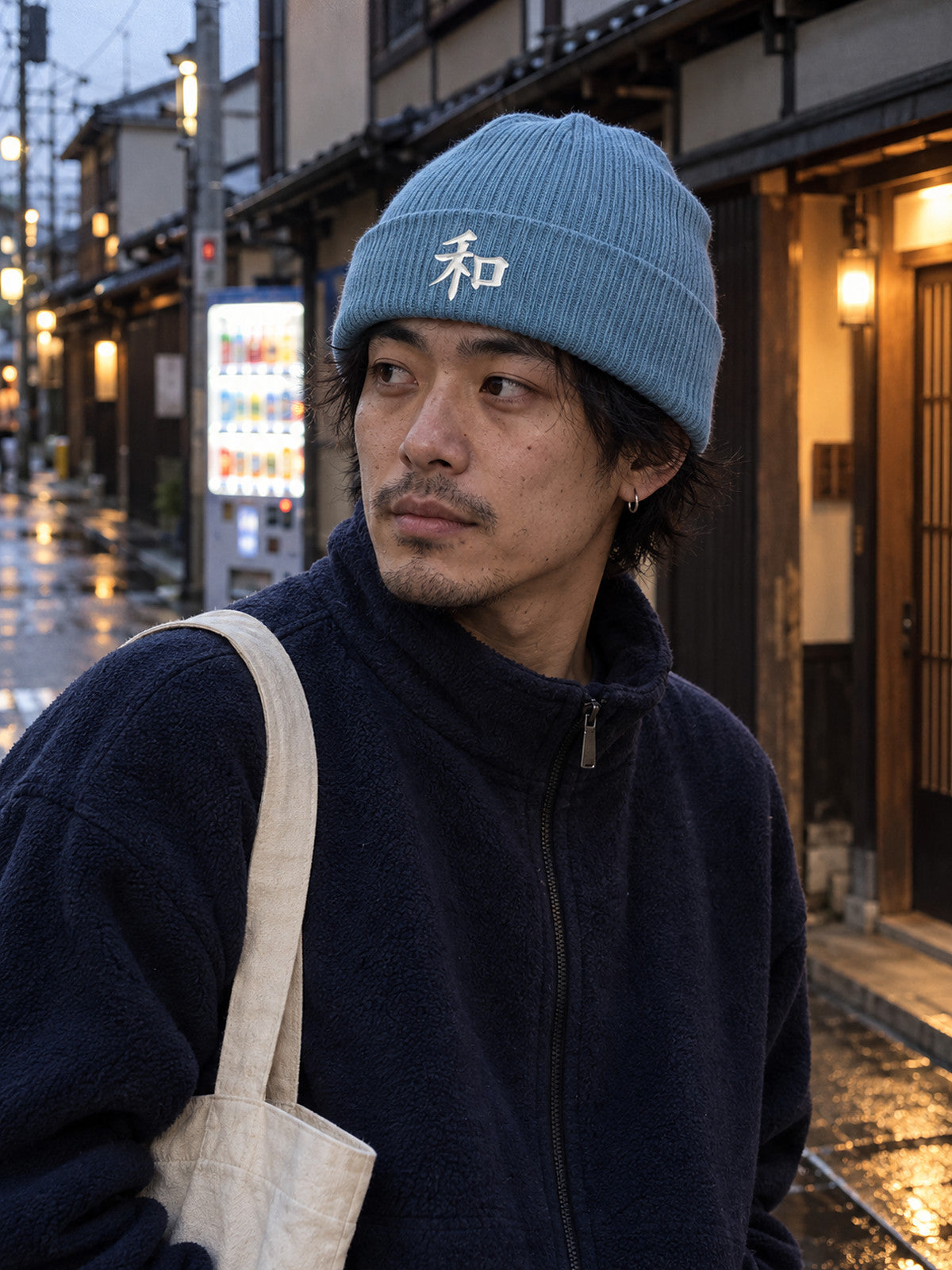 Model wearing the Light Avio Blue Kyoto Harmony 和 ribbed beanie on a quiet Kyoto side street at dusk