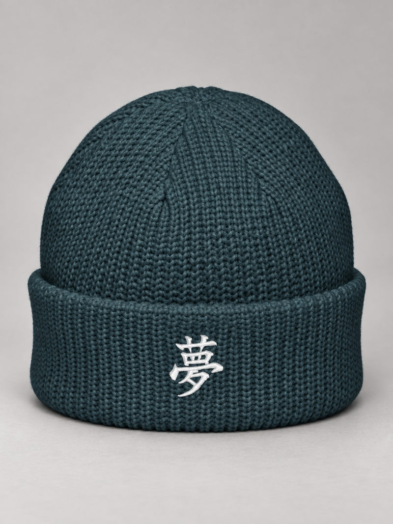 Petrol Blue Tokyo Dream 夢 fisherman beanie with the white satin-stitch 夢 embroidered on the cuff, front view