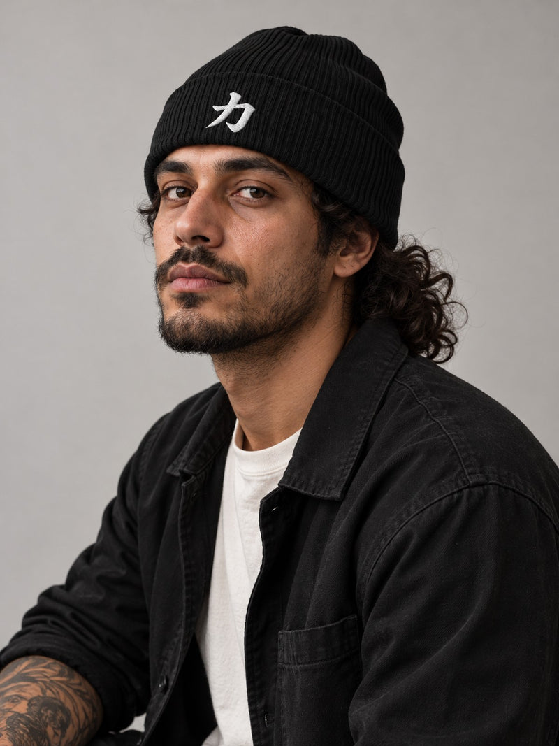 Model wearing the black Osaka Strength 力 organic cotton beanie in the studio, white 3D-puff 力 embroidered on the cuff