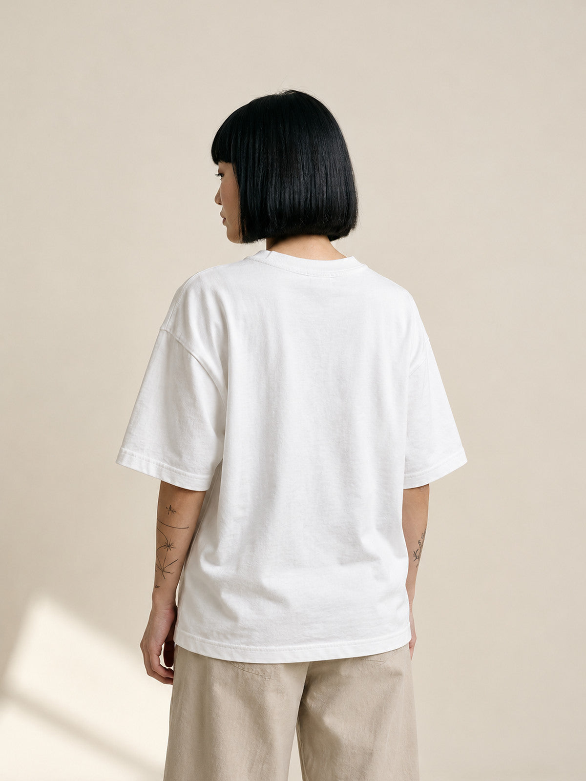 Model wearing the white Kyoto Harmony 和 premium oversized tee, back view