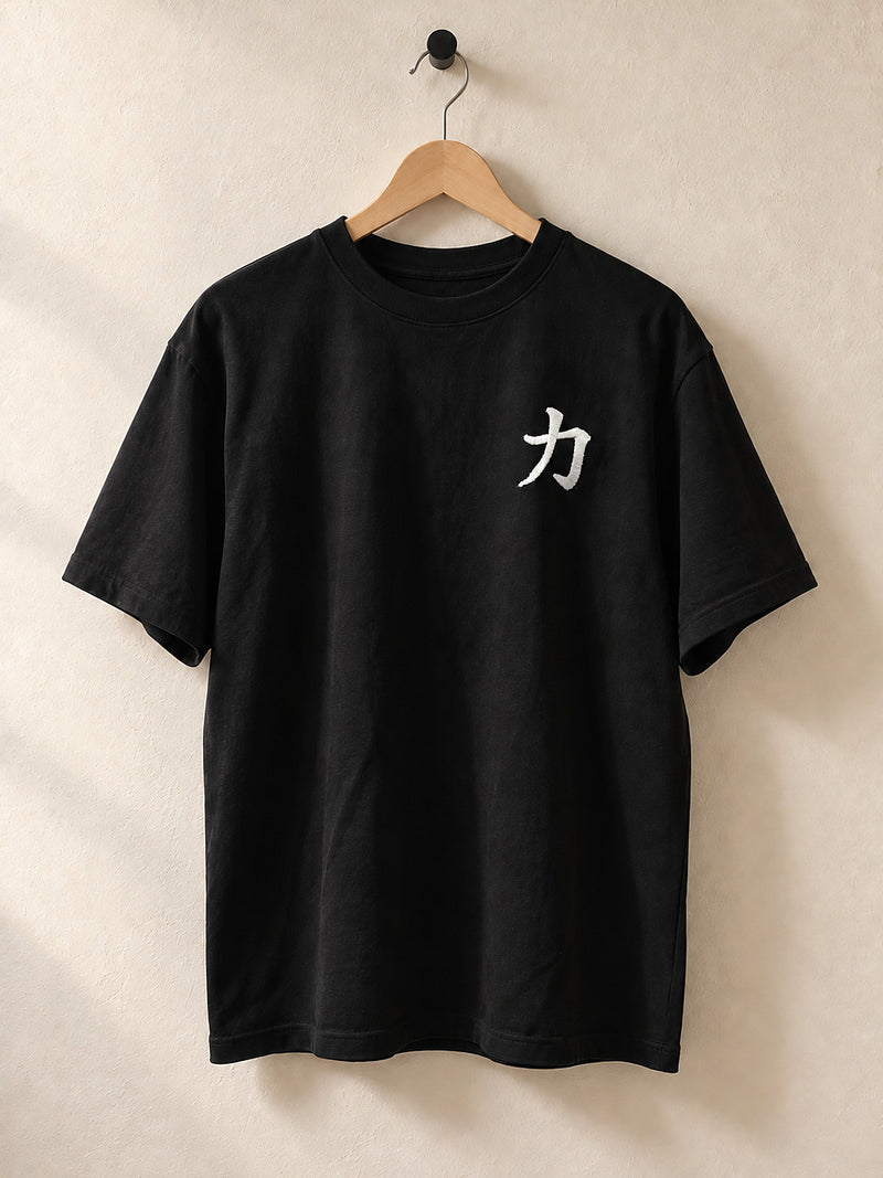 Black Osaka Strength 力 oversized tee on a wooden hanger