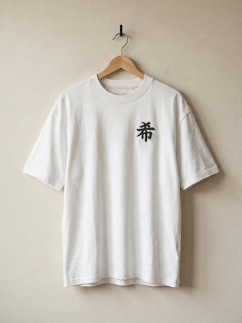 White Sapporo Hope 希 premium oversized tee on a wooden hanger, front view