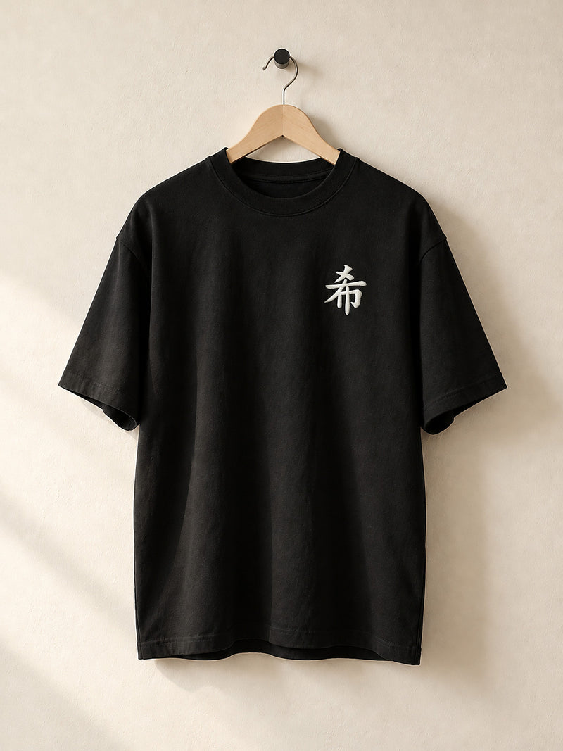 Black Sapporo Hope 希 premium oversized tee on a wooden hanger