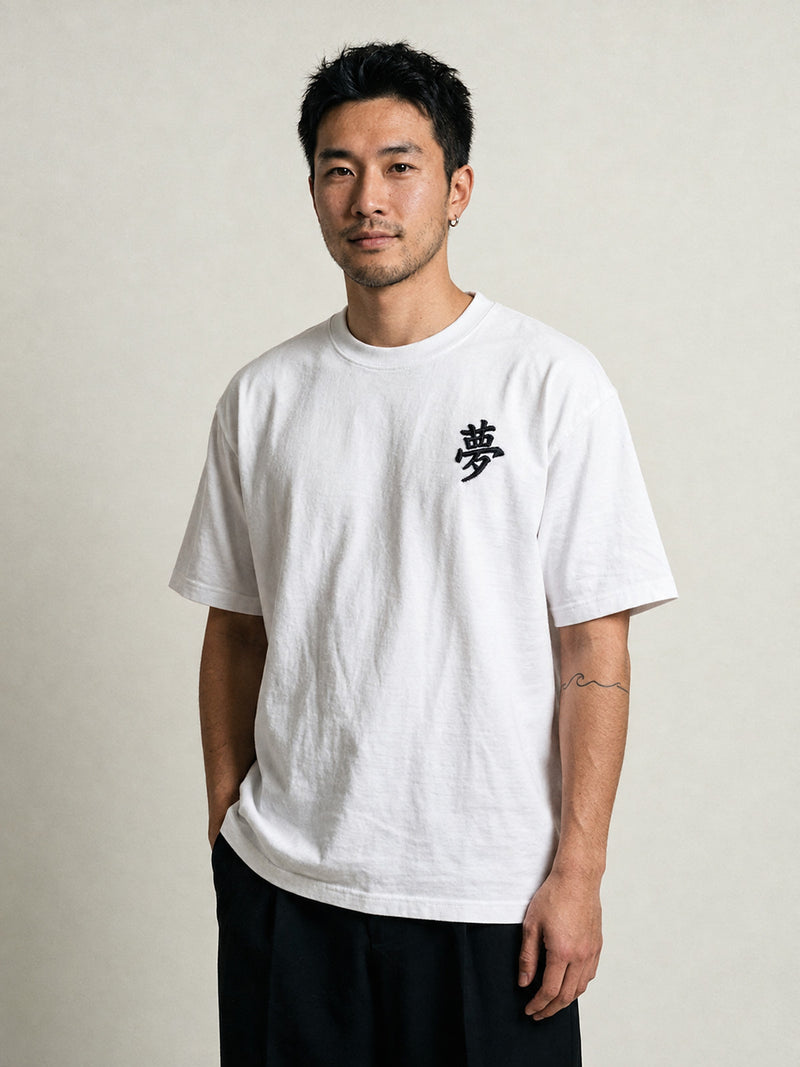 Model wearing the white Tokyo Dream 夢 premium oversized tee, front view with the black 夢 kanji embroidered on the chest