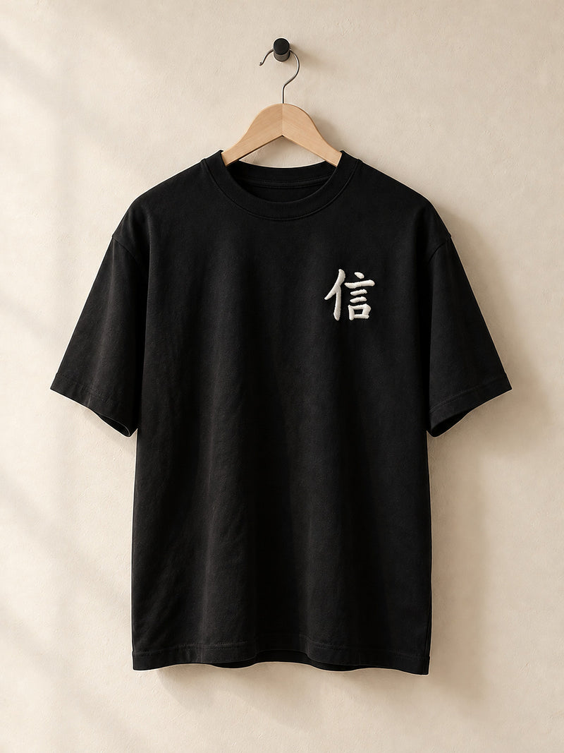 Black Yokohama Trust 信 premium oversized tee on a wooden hanger