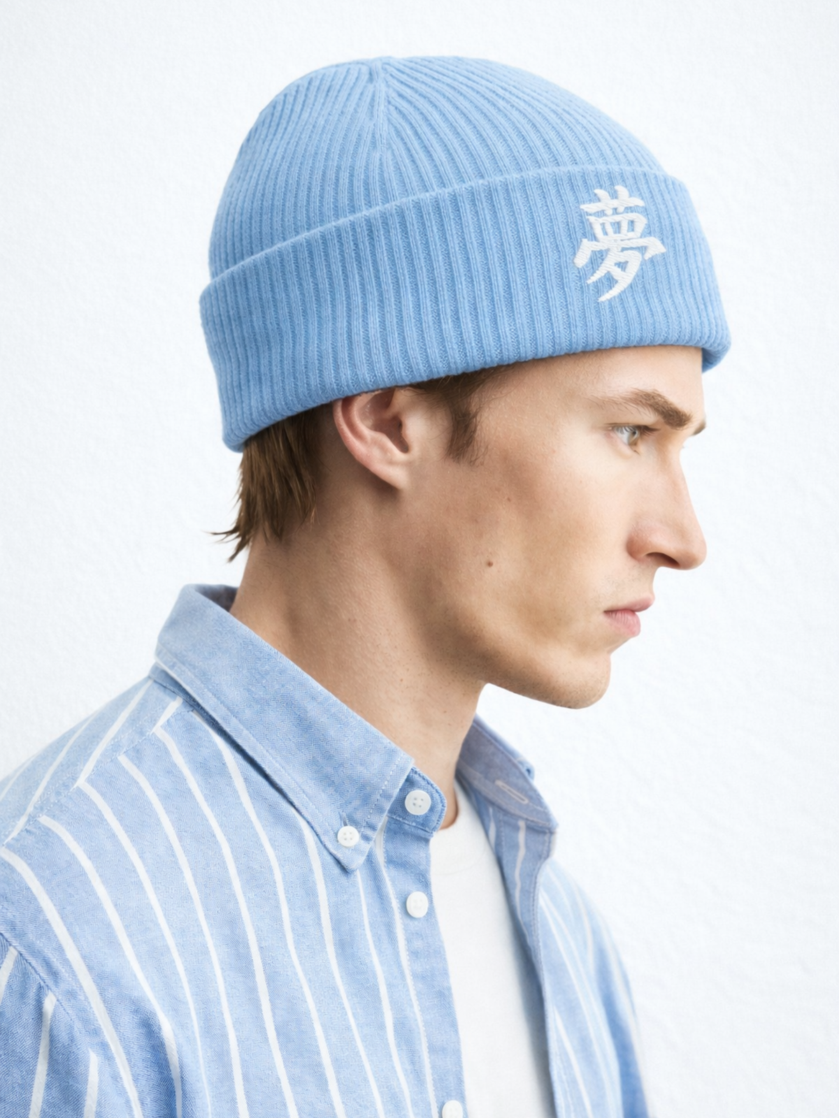 Light Avio Blue Tokyo beanie with the kanji 夢 (dream) embroidered in white on the cuff, worn by a model, side view