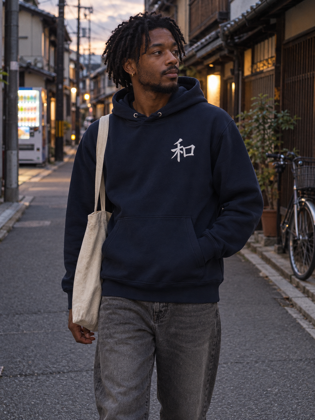 Model wearing the French Navy Kyoto Harmony 和 hoodie on a quiet Kyoto backstreet