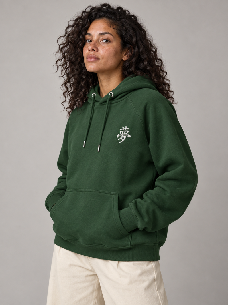 Model wearing the bottle green Tokyo Dream 夢 hoodie in the studio, small white embroidered 夢 on the left chest
