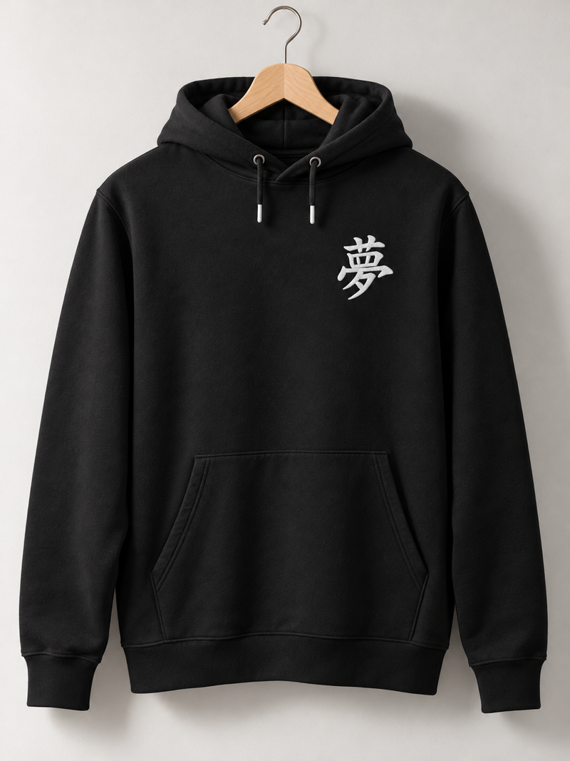 Black Tokyo Dream 夢 hoodie on a wooden hanger, front view with the small white embroidered 夢 on the left chest