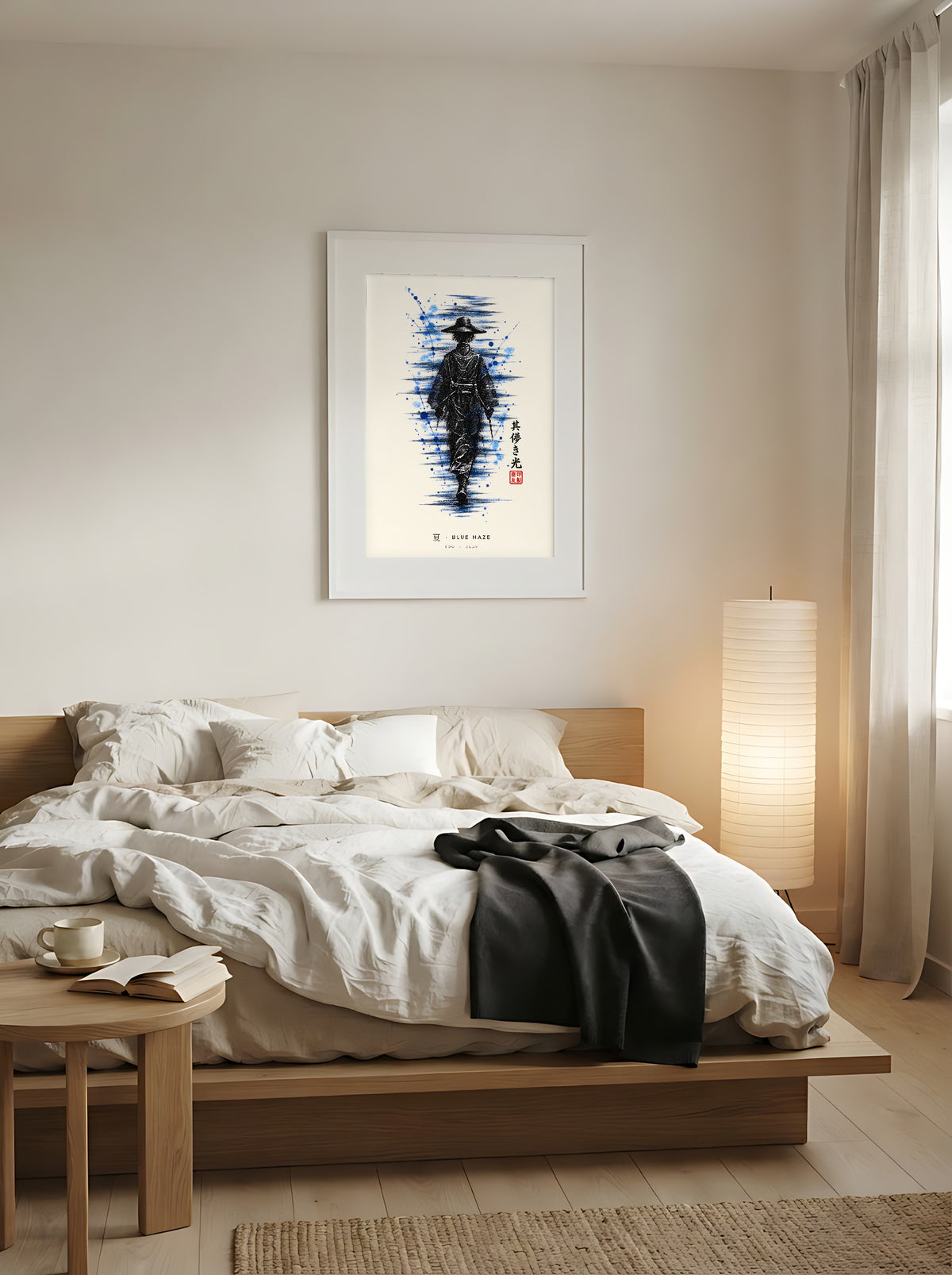 Edo Blue Haze 夏 framed print: a lone traveller in a straw hat in black ink with splashes of blue, white frame above a low oak bed in a Japandi bedroom