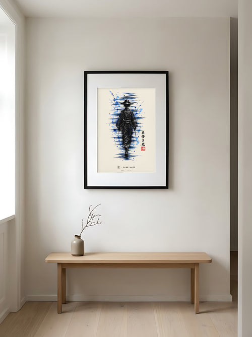 Edo Blue Haze 夏 framed print: a lone traveller in a straw hat in black ink with splashes of blue, black frame in a Japandi entryway above an oak bench