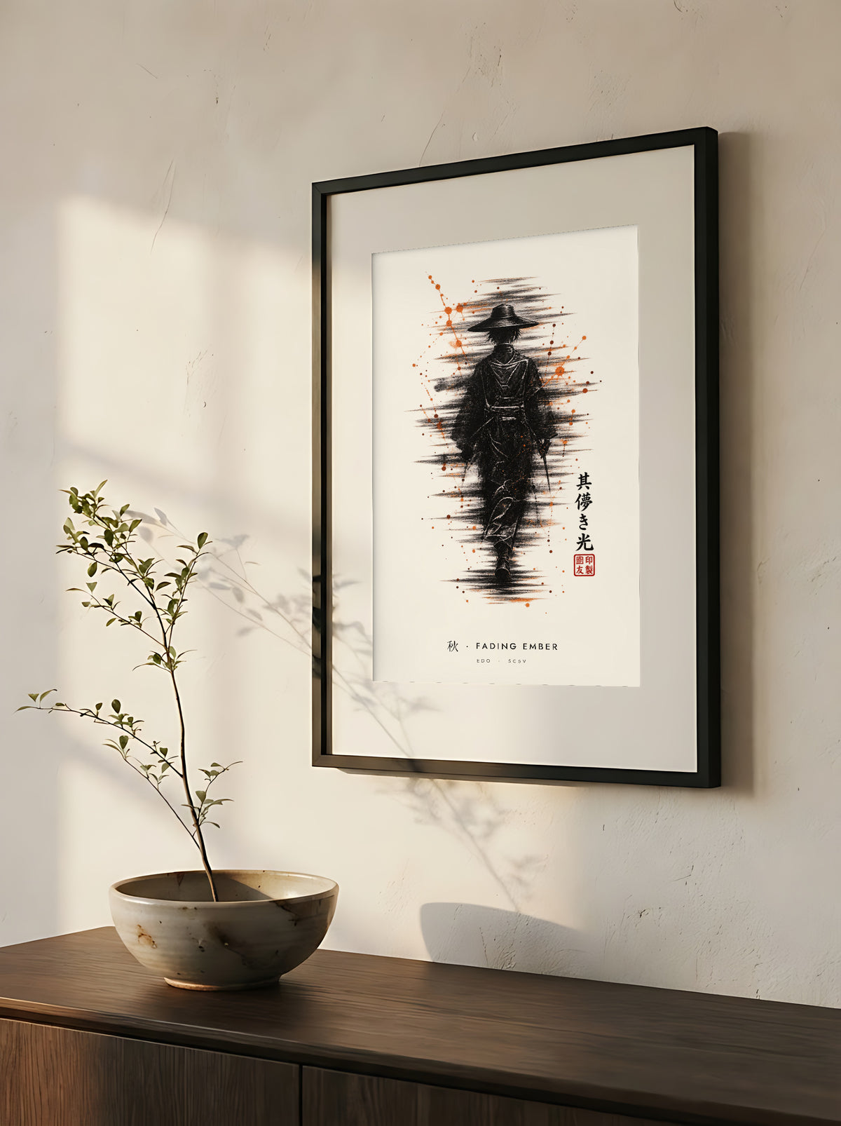 Edo Fading Ember 秋 framed print: a lone traveller in a straw hat in black ink with rising orange sparks, close-up of the black frame and white mat