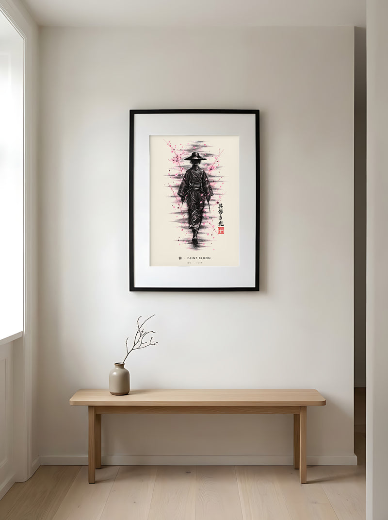 Edo Faint Bloom 春 framed print: a lone traveller in a straw hat in black ink with falling pink blossom, black frame in a Japandi entryway above an oak bench