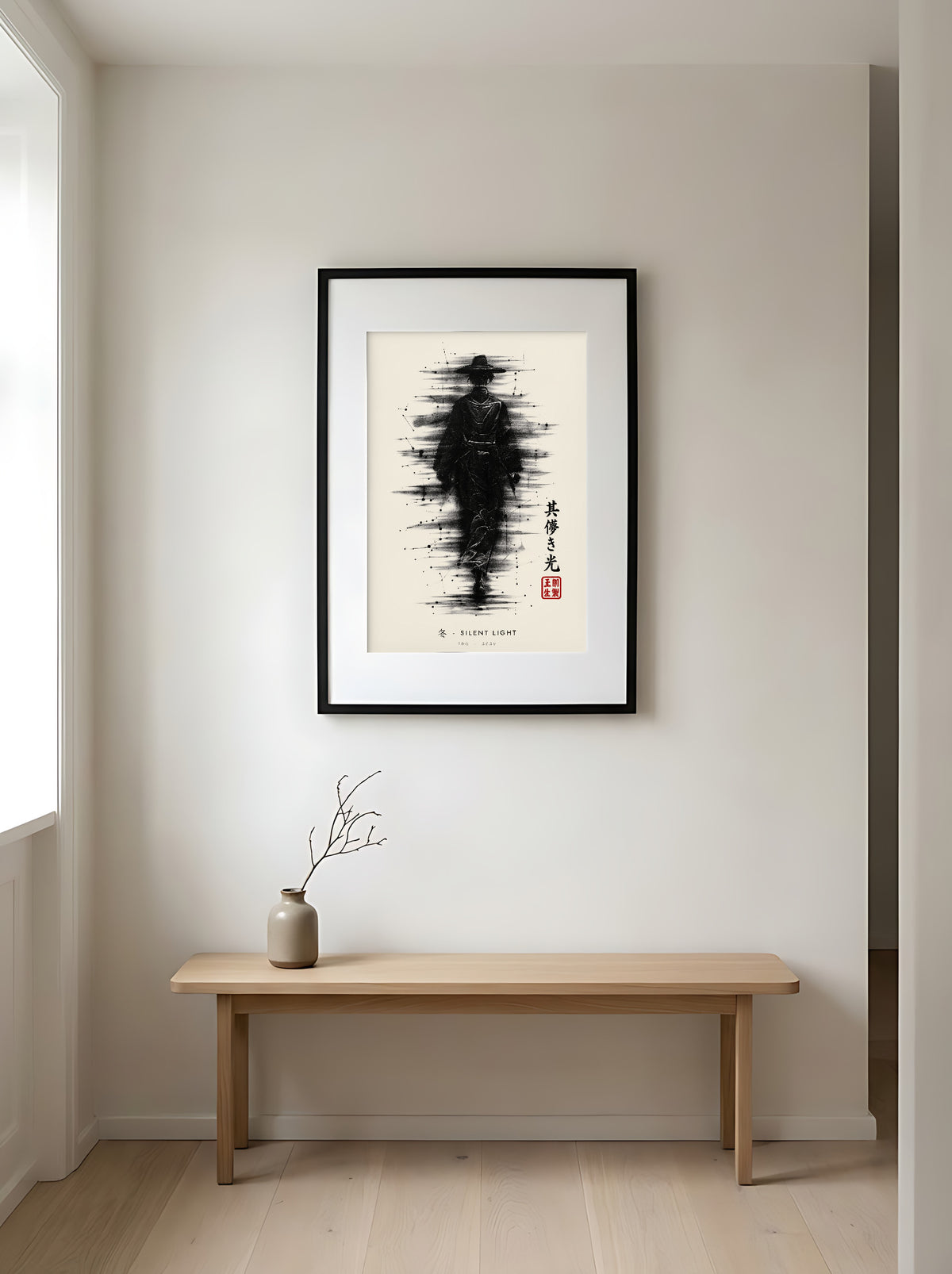 Edo Silent Light 冬 framed print: a lone traveller in a straw hat in heavy black ink, black frame in a Japandi entryway above an oak bench