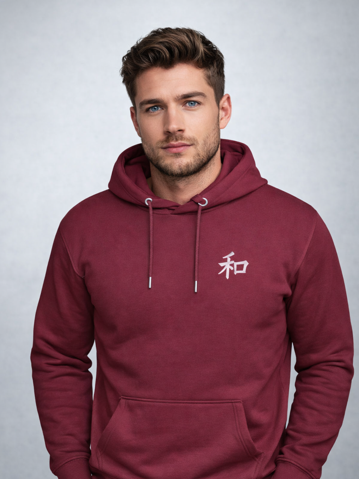 Model wearing the maroon Kyoto Harmony 和 hoodie, front view with the white 和 chest embroidery