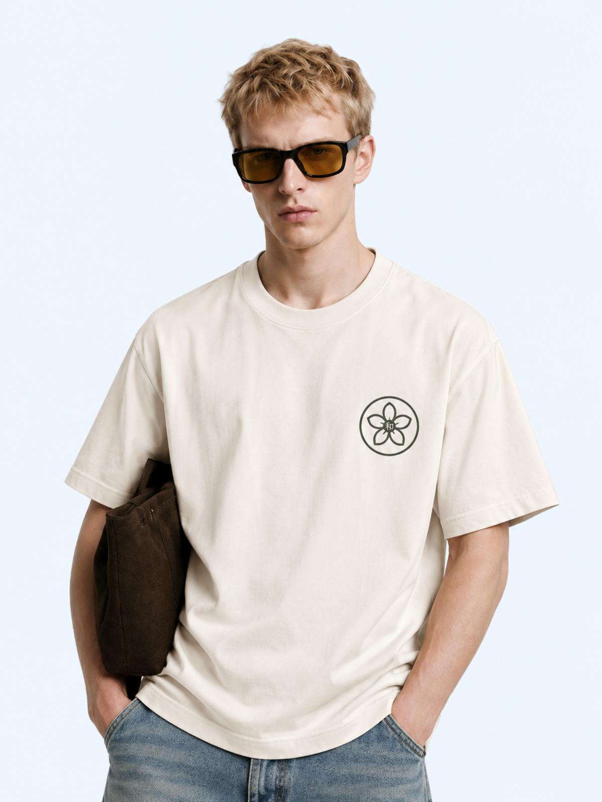 Close-up of a model in the vintage white Kyoto Harmony 和 graphic tee, sakura kamon and 和 chest print
