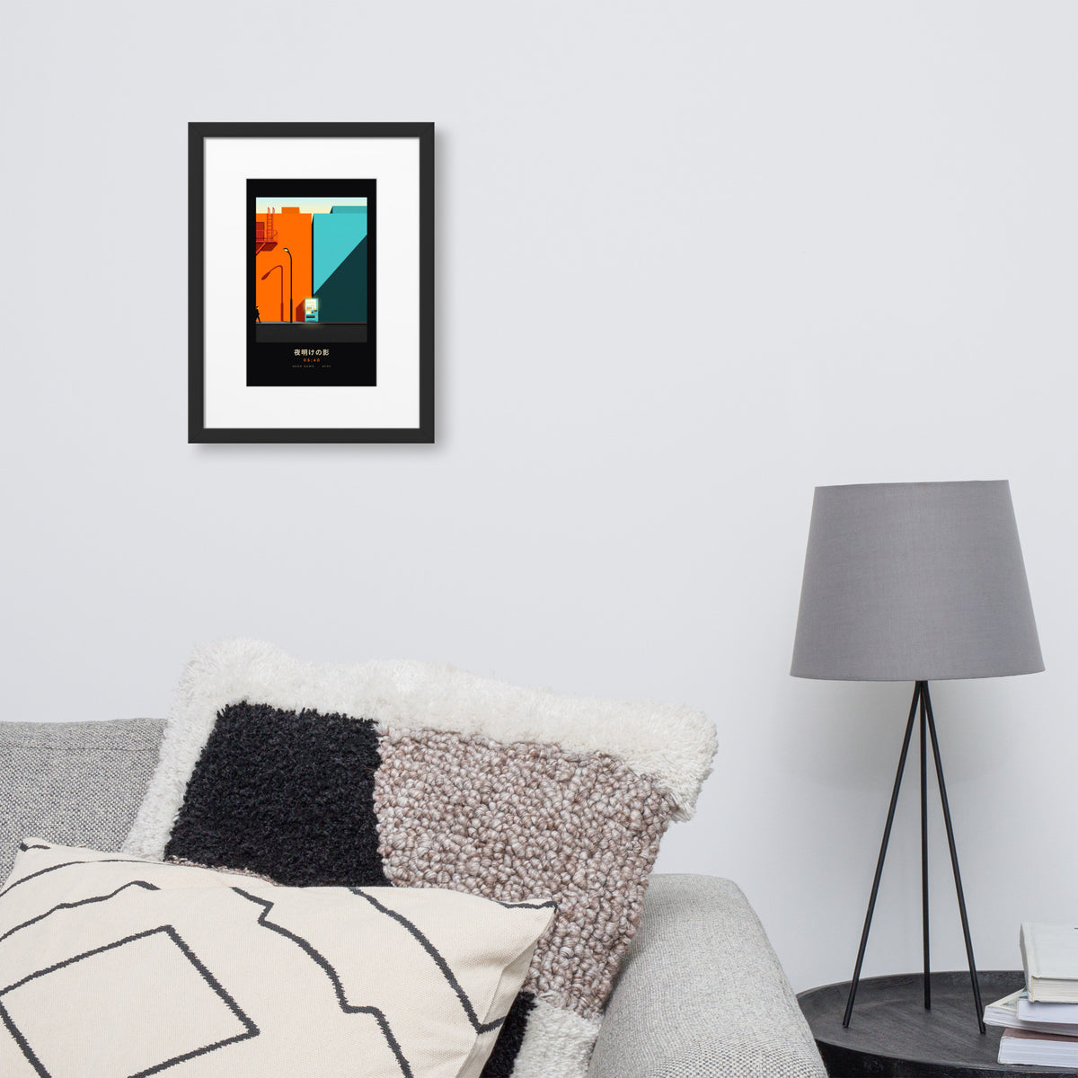 Black-framed Kage 影 (shadow) print, 30×40 cm: an orange and teal Tokyo street at dawn, on a wall over a sofa