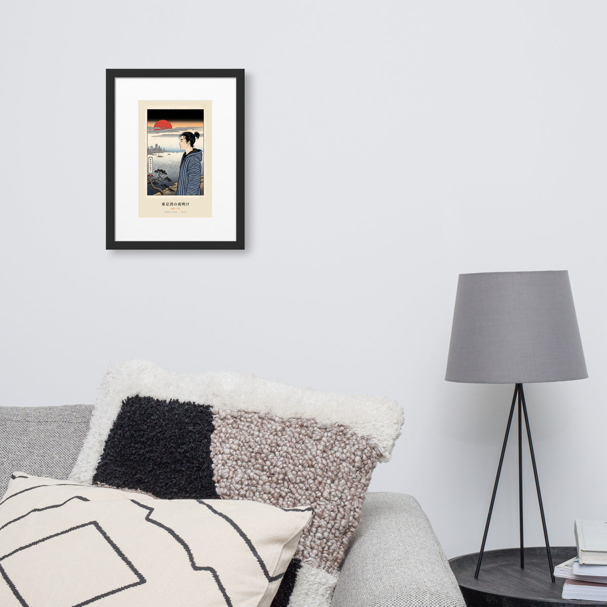 Black-framed Tokyo Bay 東京湾 print, 30×40 cm: woodblock-style dawn over Tokyo Bay, red sun, on a wall over a sofa