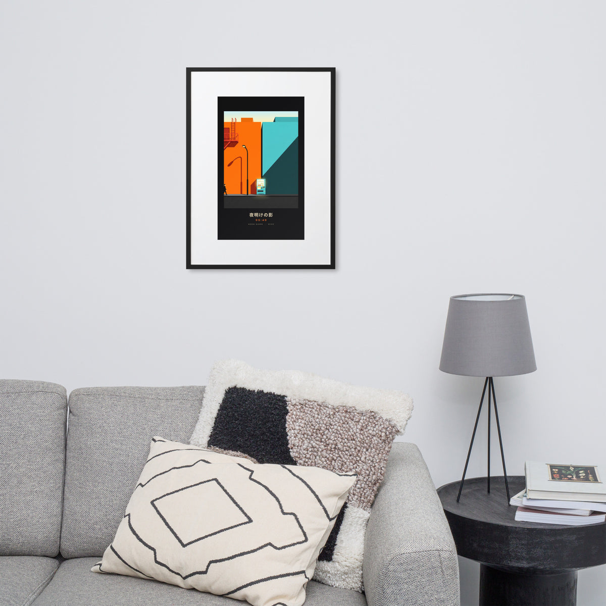 Black-framed Kage 影 (shadow) print, 50×70 cm: an orange and teal Tokyo street at dawn, on a wall over a sofa