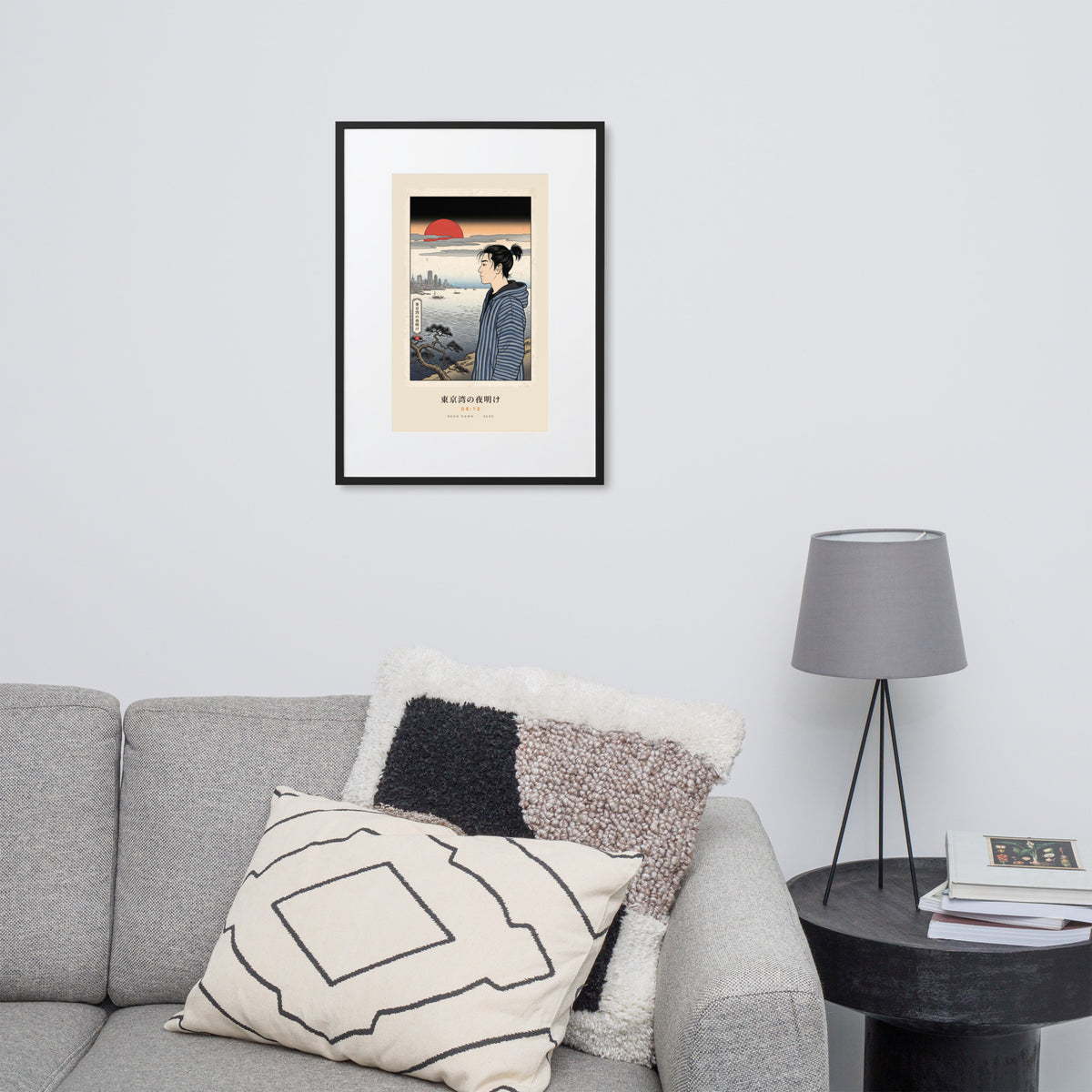 Black-framed Tokyo Bay 東京湾 print, 50×70 cm: woodblock-style dawn over Tokyo Bay, red sun, on a wall over a sofa
