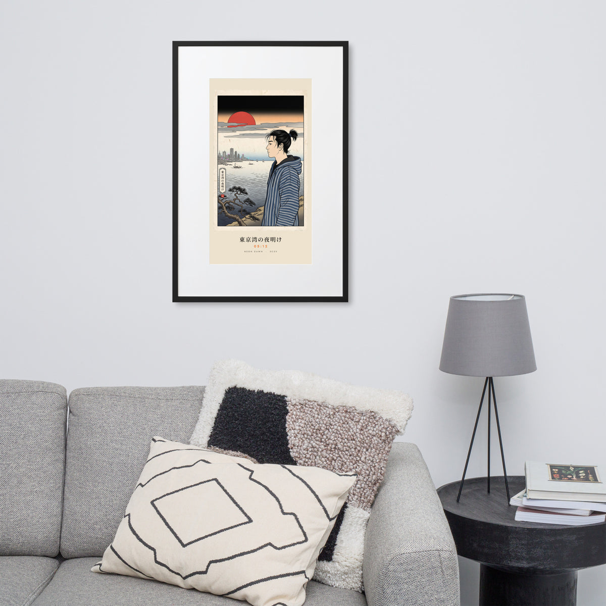 Black-framed Tokyo Bay 東京湾 print, 61×91 cm: woodblock-style dawn over Tokyo Bay, red sun, on a wall over a sofa