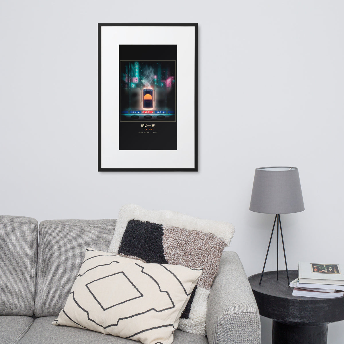 Black-framed Asa no Ippai 朝の一杯 (morning cup), 61×91 cm: a hot can glowing in a rainy vending machine, on a wall over a sofa
