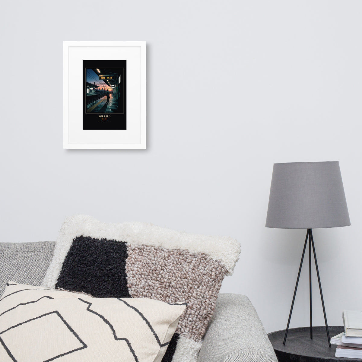 White-framed Shihatsu 始発 (first train), 30×40 cm: a commuter awaiting Tokyo's first train at sunrise, on a wall over a sofa
