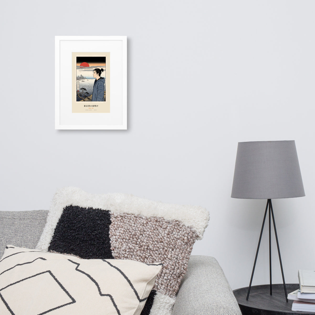 White-framed Tokyo Bay 東京湾 print, 30×40 cm: woodblock-style dawn over Tokyo Bay, red sun, on a wall over a sofa