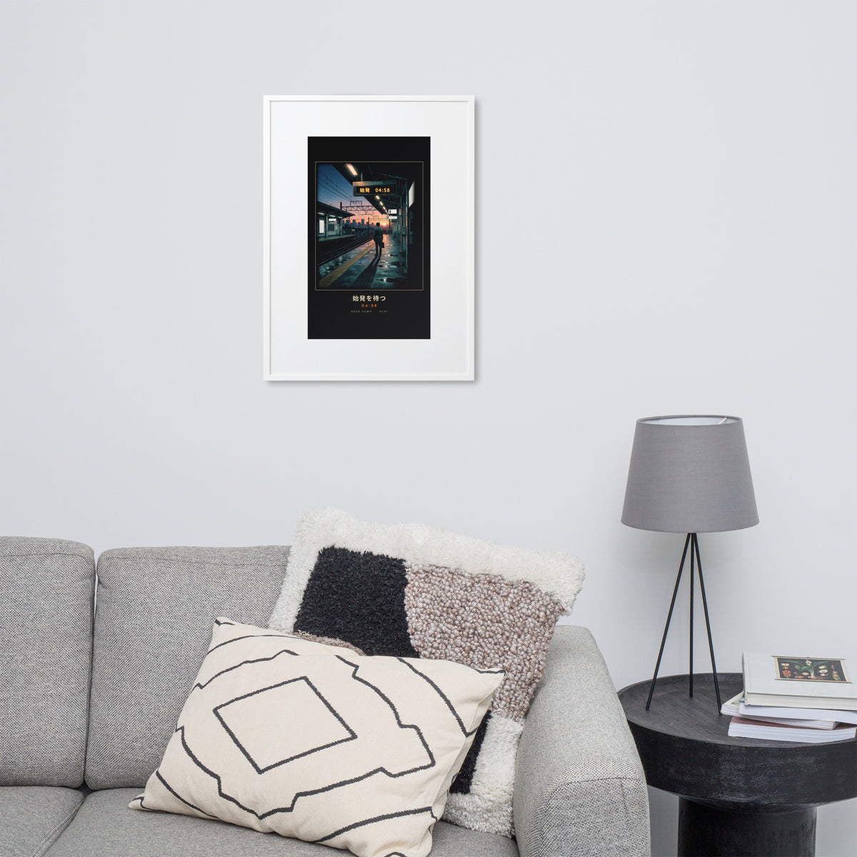 White-framed Shihatsu 始発 (first train), 50×70 cm: a commuter awaiting Tokyo's first train at sunrise, on a wall over a sofa