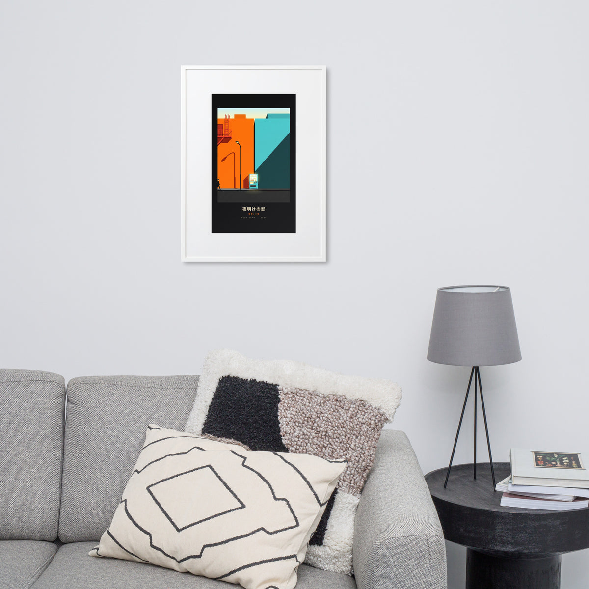 White-framed Kage 影 (shadow) print, 50×70 cm: an orange and teal Tokyo street at dawn, on a wall over a sofa