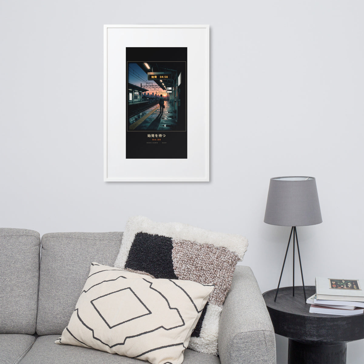 White-framed Shihatsu 始発 (first train), 61×91 cm: a commuter awaiting Tokyo's first train at sunrise, on a wall over a sofa