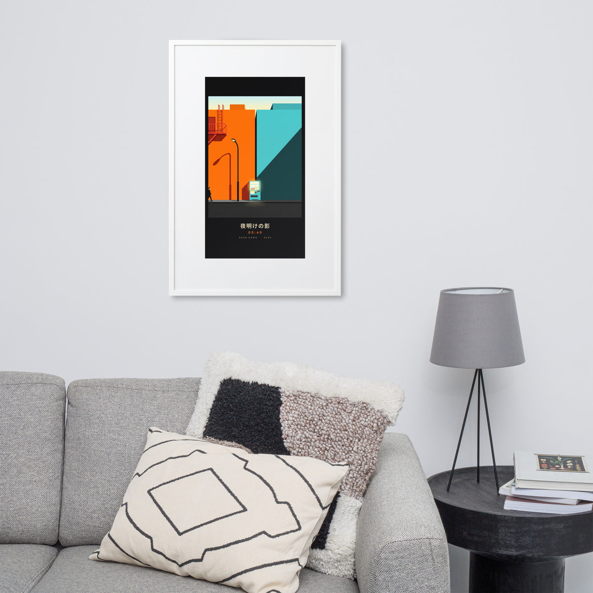 White-framed Kage 影 (shadow) print, 61×91 cm: an orange and teal Tokyo street at dawn, on a wall over a sofa