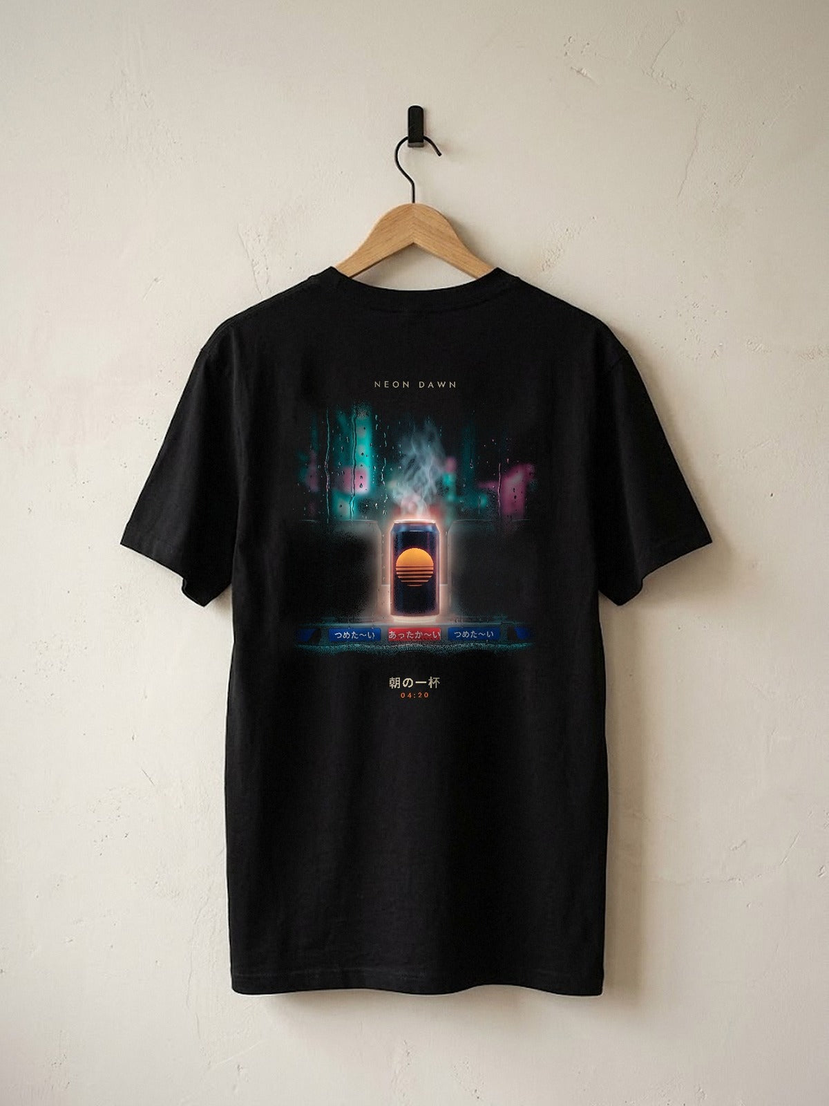 Neon Dawn Asa no Ippai 朝の一杯 heavyweight black tee on a wooden hanger against a plaster wall, showing the rainy Tokyo vending machine back print