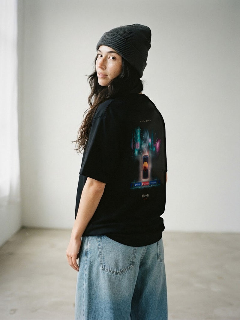 Model wearing the Neon Dawn Asa no Ippai 朝の一杯 black tee from behind, showing the rainy Tokyo vending machine back print, printed full width