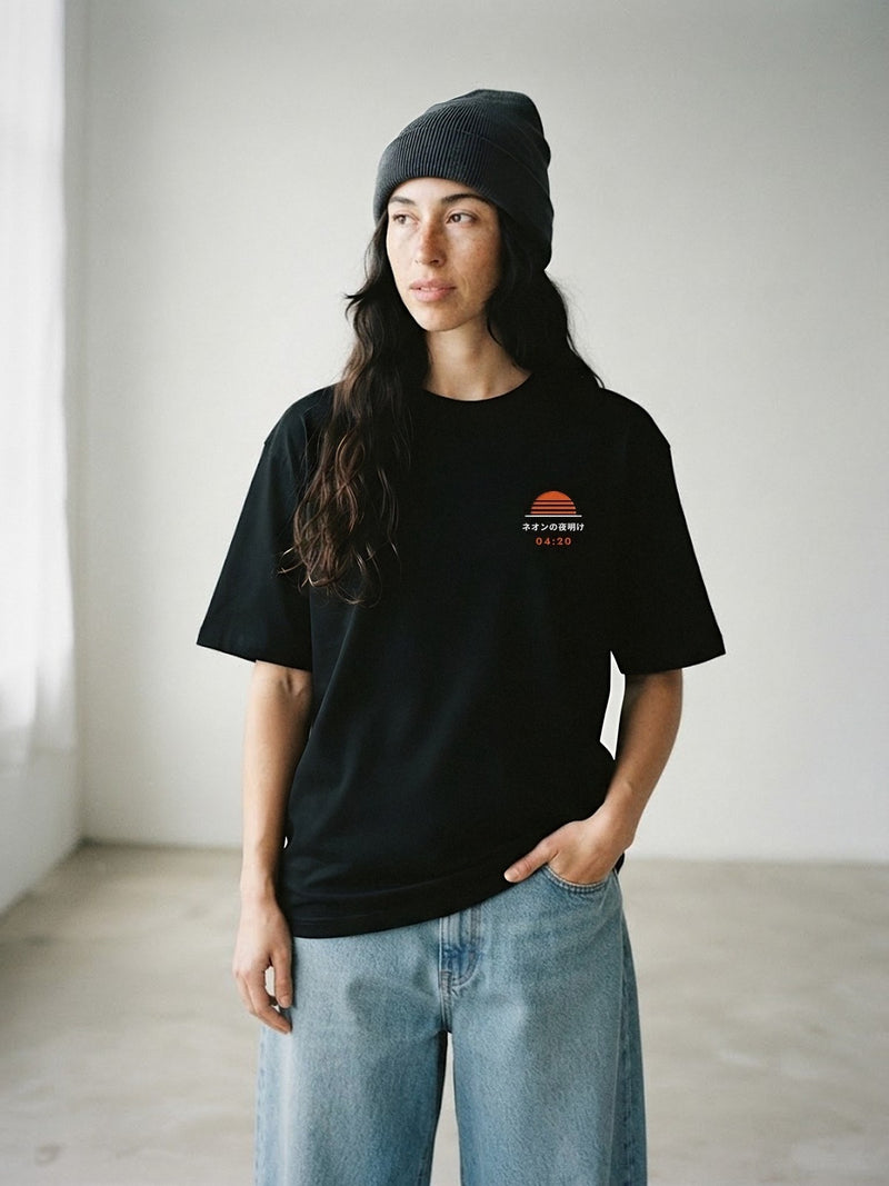 Model wearing the Neon Dawn Asa no Ippai 朝の一杯 black tee, front view with the embroidered 04:20 Neon Dawn sun on the chest