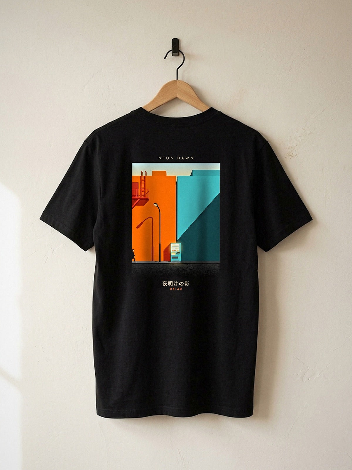 Neon Dawn Kage 影 heavyweight black tee on a wooden hanger against a plaster wall, showing the orange and teal 05:40 Tokyo shadows back print
