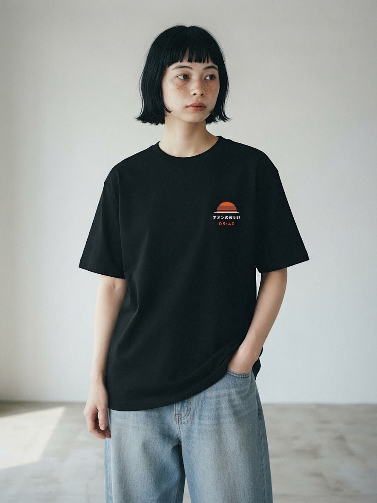 Model wearing the Neon Dawn Kage 影 black tee, front view with the embroidered 05:40 Neon Dawn sun on the chest