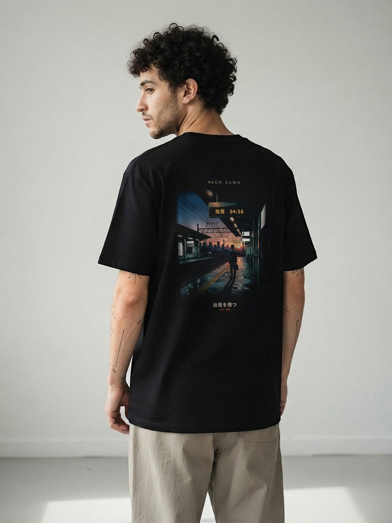 Model wearing the Neon Dawn Shihatsu 始発 black tee from behind, showing the 04:58 Tokyo first-train back print, printed full width