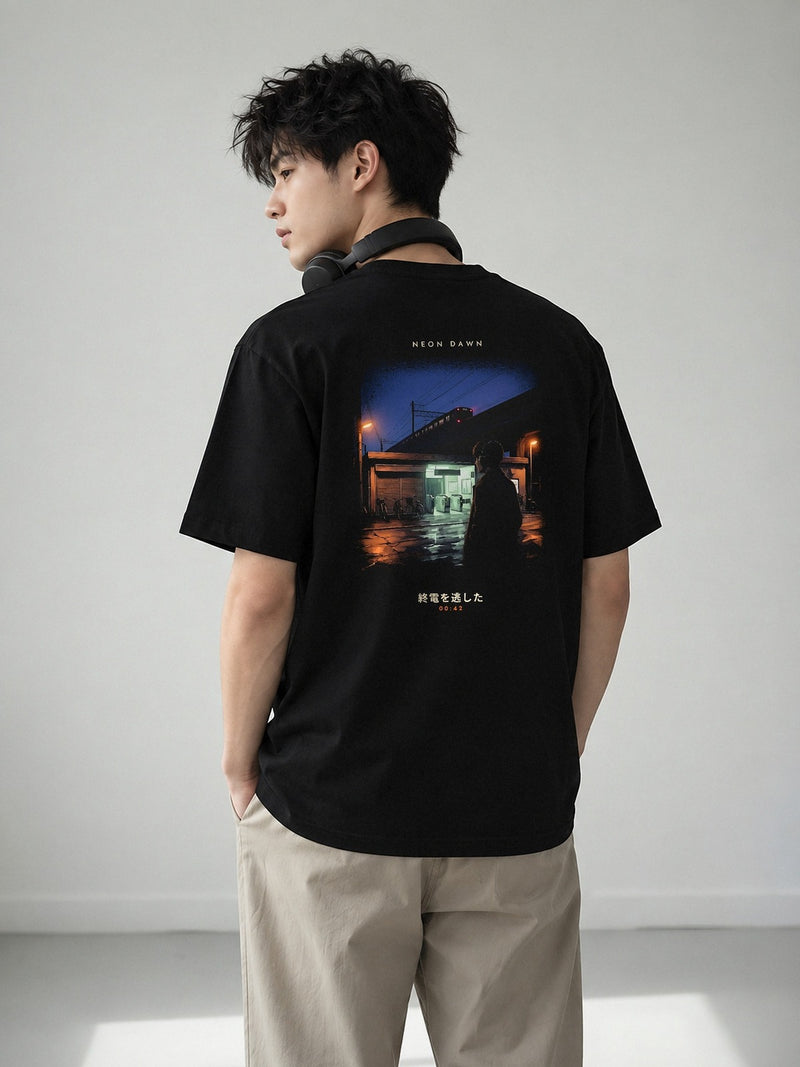 Model wearing the 5C5V Neon Dawn Shūden 終電 black tee from the back, showing the last train at 00:42 printed full width