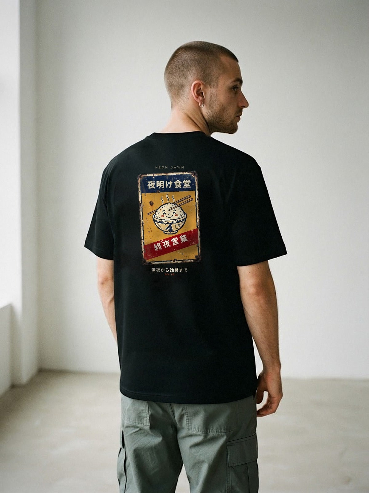 Model wearing the Neon Dawn Shuya Eigyo 終夜営業 black tee from behind, showing the open-all-night Tokyo diner sign back print
